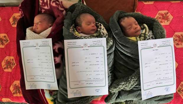 Palestinian newborn triplets of the al-Saiqli family, named (R to L) ,Quds, (Arabic for Jerusalem), ,Palestine,, and ,Capital,, as they lie sleeping with their birth certificates placed above them