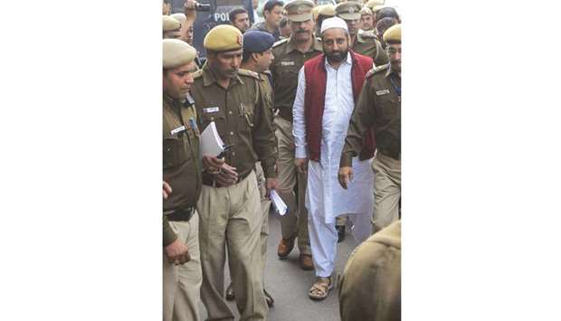 Aam Aadmi Party MLA Amanatullah Khan being taken to the Tees Hazari Court in New Delhi yesterday.