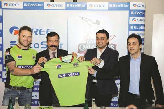 Fawad Rana (second left), Managing Director of Qalco and Chairman of Lahore Qalandars and team captain Brendon McCullum (left) at a sponsorship signing ceremony in Dubai, ahead of the Pakistan Super League.