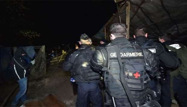 French gendarmes try to evacuate opponents of a nuclear waste burial site in the Lejuc woods in Bure early on Thursday.