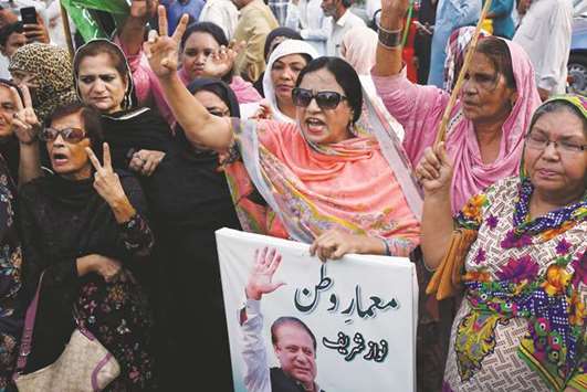Supporters of the ruling Pakistan Muslim League (Nawaz) chant slogans during a protest in Karachi yesterday.