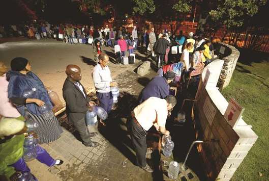 People queue to collect water from a spring in the Newlands suburb as fears over the cityu2019s water crisis grow in Cape Town, South Africa.