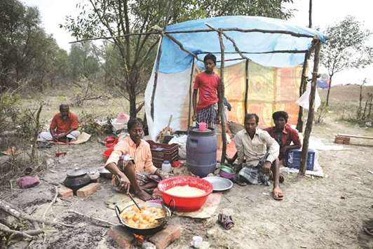 A man cooks a meal in his makeshift restaurant on the Bangladeshi island of Bhasan Char in the Bay of Bengal.
