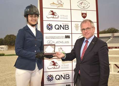 In Shaallah Saad Hameed receives her prize after finishing third in the Small Tour 110/120cm class.