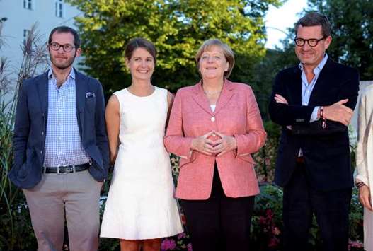 From left: In this file photo, chief editors of Bild newspaper Julian Reichelt and Tanit Koch, Germanyu2019s Chancellor Angela Merkel and then chief editor Kai Diekmann attend the u201cBild 100u201d event in Berlin, Germany.
