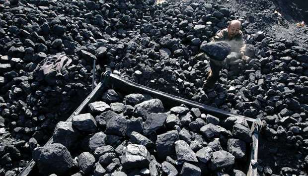 A worker loads coal onto a cart at a coal mine in Taiyuan, Shanxi province.