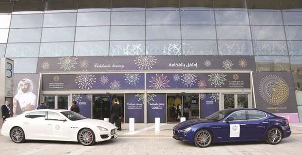The Maserati Quattroporte and Ghibli flank the entrance of the DJWE venue.