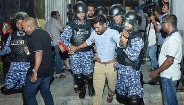Maldivian police officers detain an opposition protester demanding the release of political prisoners, in Male earlier this week.