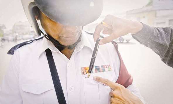 A pen with a spy camera being placed in a traffic policemanu2019s pocket.
