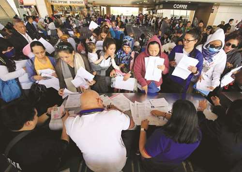 Around 190 Overseas Filipino Workers (OFW) from the Middle East submit their documents upon their arrival at the Ninoy Aquino International Airport, following President Rodrigo Duterteu2019s call to evacuate workers, in Pasay city, Metro Manila, yesterday.