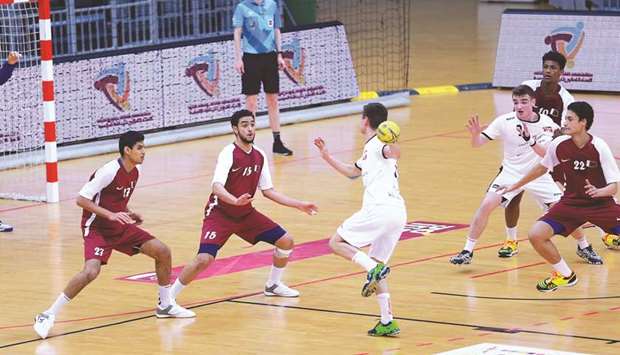 Qatari players defend as a Poland player tries to score during group match of the ISF World Schools Handball Championship at Ali Bin Hamad Al Attiyah Arena in Doha yesterday.