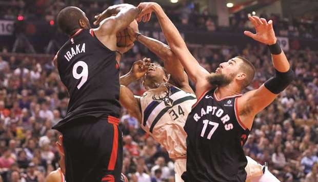 Toronto Raptors forward Serge Ibaka (9) takes a rebound away from Milwaukee Bucks forward Giannis Antetokounmpo (34) as Toronto Raptors center Jonas Valanciunas (17) helps out during the first half of their game on Friday. PICTURE: John E. Sokolowski-USA TODAY Sports