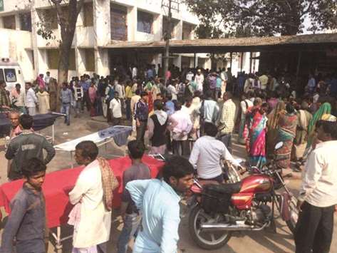 Relatives wait outside a hospital where many of the students injured in the Muzaffarpur accident are admitted.