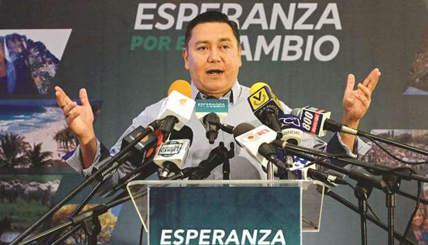 Venezuelan opposition presidential pre-candidate and evangelical pastor Javier Bertucci gestures during a press conference in Caracas.