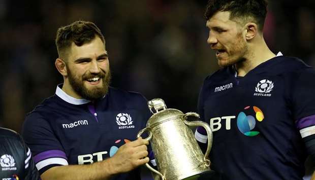 Scotlandu2019s Jamie Bhatti and Tim Swinson celebrate with the Calcutta Cup trophy after their victory over England yesterday.