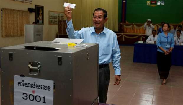 Cambodia's Prime Minister and President of the Cambodian People's Party (CPP), Hun Sen shows a ballot during a Senate election in Takhmao