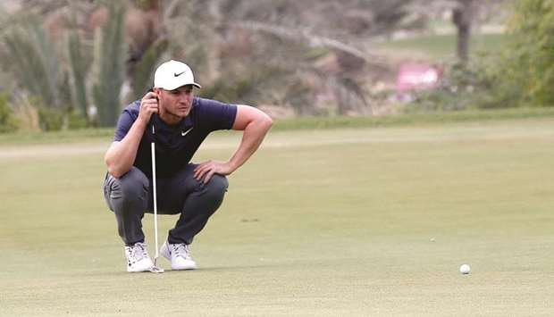 Oliver Fisher lines up a shot at the Doha Golf Club yesterday. At right, Eddie Pepperell in action. PICTURES: Jayaram