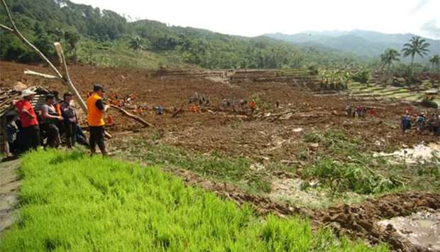 Members of a rescue team join villagers as they search for victims of a landslide triggered by a heavy rain in Brebes, Central Java province last week.
