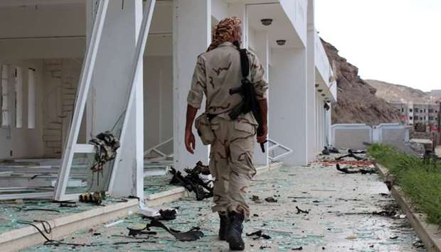 A fighter from the separatist Southern Transitional Council gather at the site of two suicide car bombings that targeted the headquarters of an anti-terror unit the day before, in the southern Yemeni port of Aden.