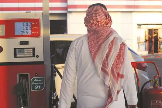 A Saudi man walks past a pump at a petrol station in Jeddah (file). The VAT rollout and more expensive fuel had a large impact on Saudi consumer spending power in some areas last month, according to official data.