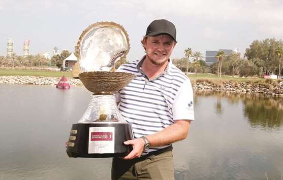 Eddie Pepperell of England lifts Mother Of Pearl Trophy after winning Commercial Bank Qatar Masters at Doha Golf Club yesterday. PICTURE: Jayaram