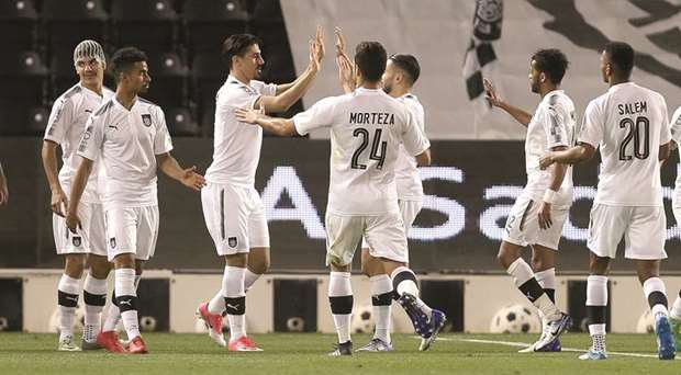 Baghdad Bounedjah (third from left) is congratulated by his teammates after scoring against Al Ahli yesterday in the QNB Stars League yesterday. At bottom,  action from the Al Rayyan u2013 Qatar Sports Club. match