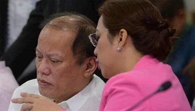 Former Philippine president Benigno Aquino (L) listens to former Philippine health secretary Janette Garin (R)