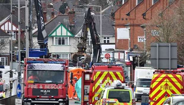 Members of the emergency services work with heavy machinery at the scene of an explosion in Leicester, central England, on Monday.