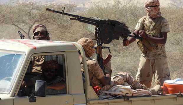 Yemeni fighters loyal to the government backed by the Saudi-led coalition fighting in the country ride in the back of a pickup truck with mounted heavy machine gun in the province of Hadramawt. February 21, 2018 file picture.