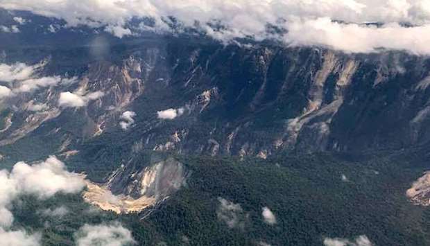 A handout photo shows several landslides on mountains in the Muller range after an earthquake struck Papua New Guinea