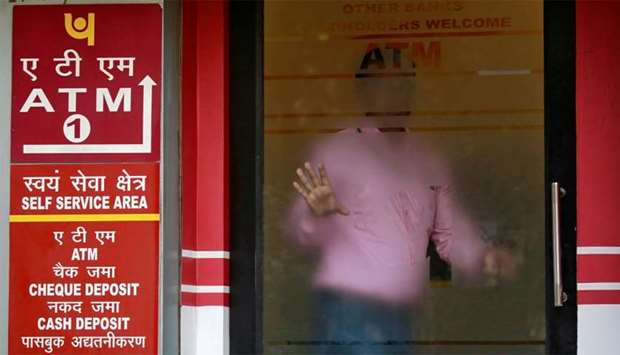 A man leaves an automated teller machine facility of Punjab National Bank