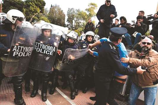 Police tries to push back a protester during a demonstration against an educational reform law to be voted in front of the Greek parliament in central Athens on February 26. Greeceu2019s creditors begin in Athens the examination of a last package of reforms to be adopted before the end of the Greek bailout programme scheduled for August.