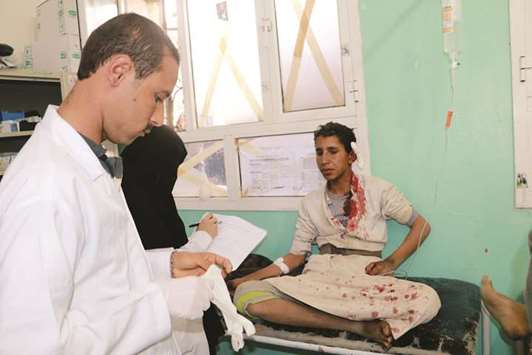A man injured by an air strike sits on a stretcher at a hospital in Saada, Yemen, yesterday.