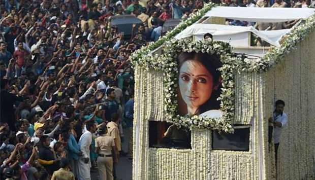 Indian fans watch as the funeral cortege of the late Bollywood actress Sridevi Kapoor passes through Mumbai on Wednesday.