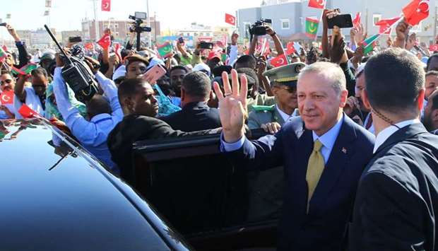 Turkish President Recep Tayyip Erdogan (R) waving to a crowd after his arrival in Nouakchott