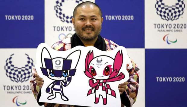 The designer of winning mascots Ryo Taniguchi poses for a photograph during a news conference after Tokyo Olympics organizers unveiled the mascots for the Tokyo 2020 Olympics and Paralympics in Tokyo