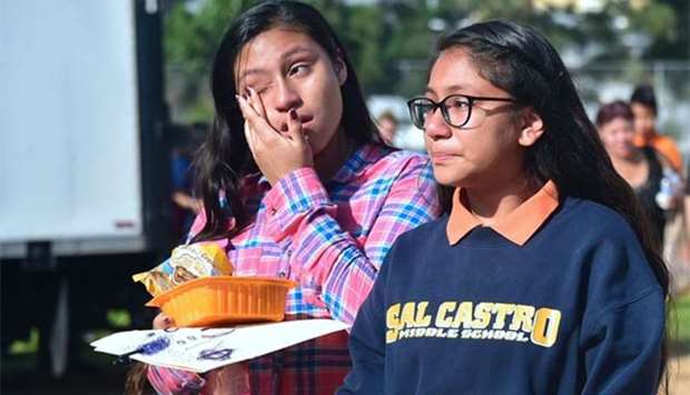 Students react while leaving campus at Salvadore Castro Middle School in Los Angeles on Thursday.