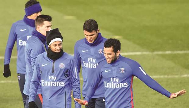 From left: Paris Saint-Germainu2019s Neymar, Thiago Silva and Dani Alves take part in a training session in Paris yesterday. (AFP)