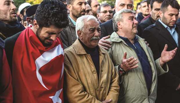 People react during a funeral ceremony for a man killed by rocket fire in Reyhanli, a town close to the Syrian border, yesterday in Hatay, southern Turkey.