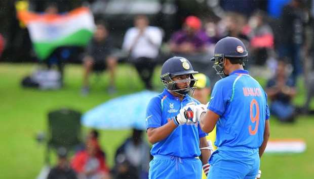 India's Manjot Kalra (R) celebrates after hitting a four with teammate Prithvi Shaw (R) during the U19 cricket World Cup final match