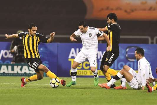 Al Saddu2019s Xavi (second from left) in action against Qatar SC during their QNB Stars League match yesterday. PICTURE: Noushad Thekkayil