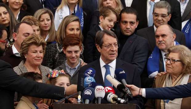 Presidential candidate Nicos Anastasiades talks to the media after casting his ballot