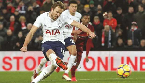 Tottenhamu2019s Harry Kane scores their second goal from a penalty during their English Premier League match against Liverpool at Anfield in Liverpool, England, yesterday. (Reuters)