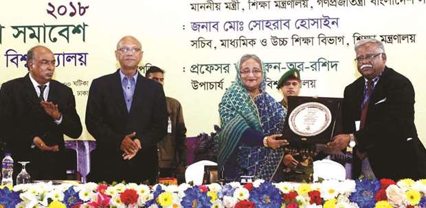 National University vice chancellor Dr Harun-or Rashid handing over a crest to Prime Minister Sheikh Hasina yesterday in Dhaka.