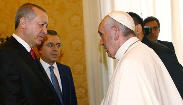 Turkish President Recep Tayyip Erdogan (L) shakes hands with Pope Francis (R) prior to their meeting in Vatican City