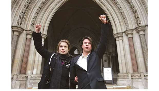 Lauri Love, who is accused of hacking into US government websites, poses with his girlfriend Sylvia Mann outside the Royal Courts of Justice in central London yesterday.