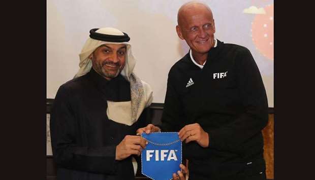 Former Italian referee Pierluigi Collina and FIFA Chairman of the Referees Committee (R) poses with Hani Taleb Ballan, Qatar Stars League CEO and Vice Chairman of the FIFA Referees Committee during 2018 FIFA World Cup Russia Referees Seminar Opening Ceremony in Doha.
