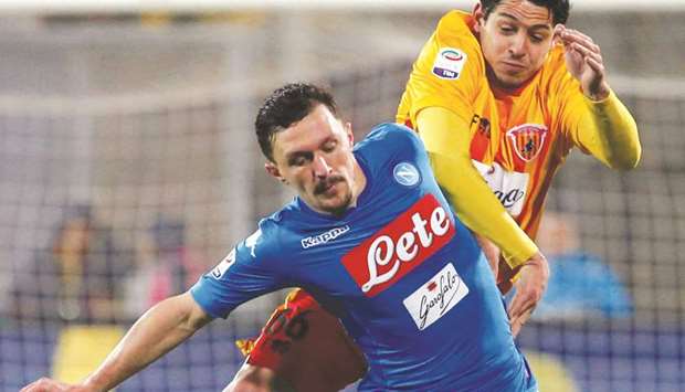 Napoliu2019s Mario Rui (left) and Beneventou2019s Guilherme vie for the ball on Sunday night.  (Reuters) Napoli beat Benevento to stay top/AFP-Milan