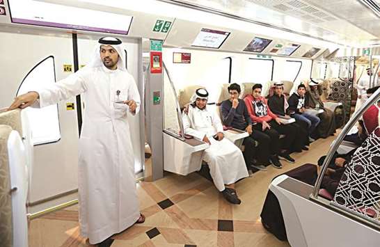 Students listening to a Qatar Rail representative during their visit to one of the stations.