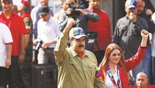Venezuelau2019s President Nicolas Maduro and his wife Cilia Flores gesture as they arrive for a rally to commemorate the 26th anniversary of late Venezuelan president Hugo Chavezu2019s failed coup attempt in Caracas, Venezuela.